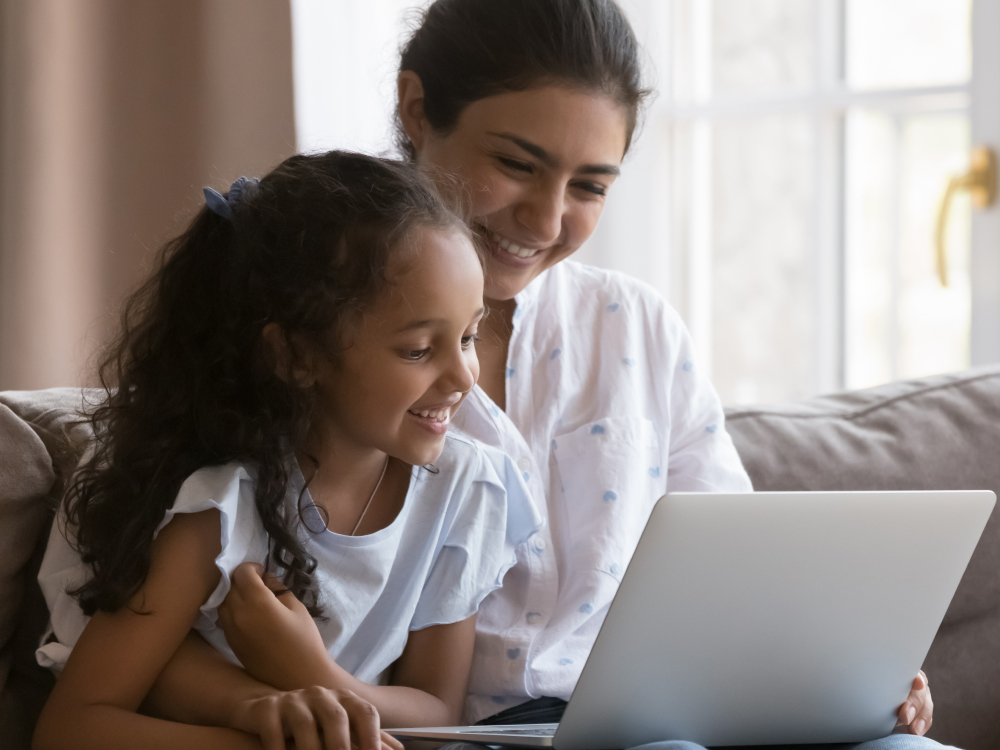 Mom and daughter learning on laptop